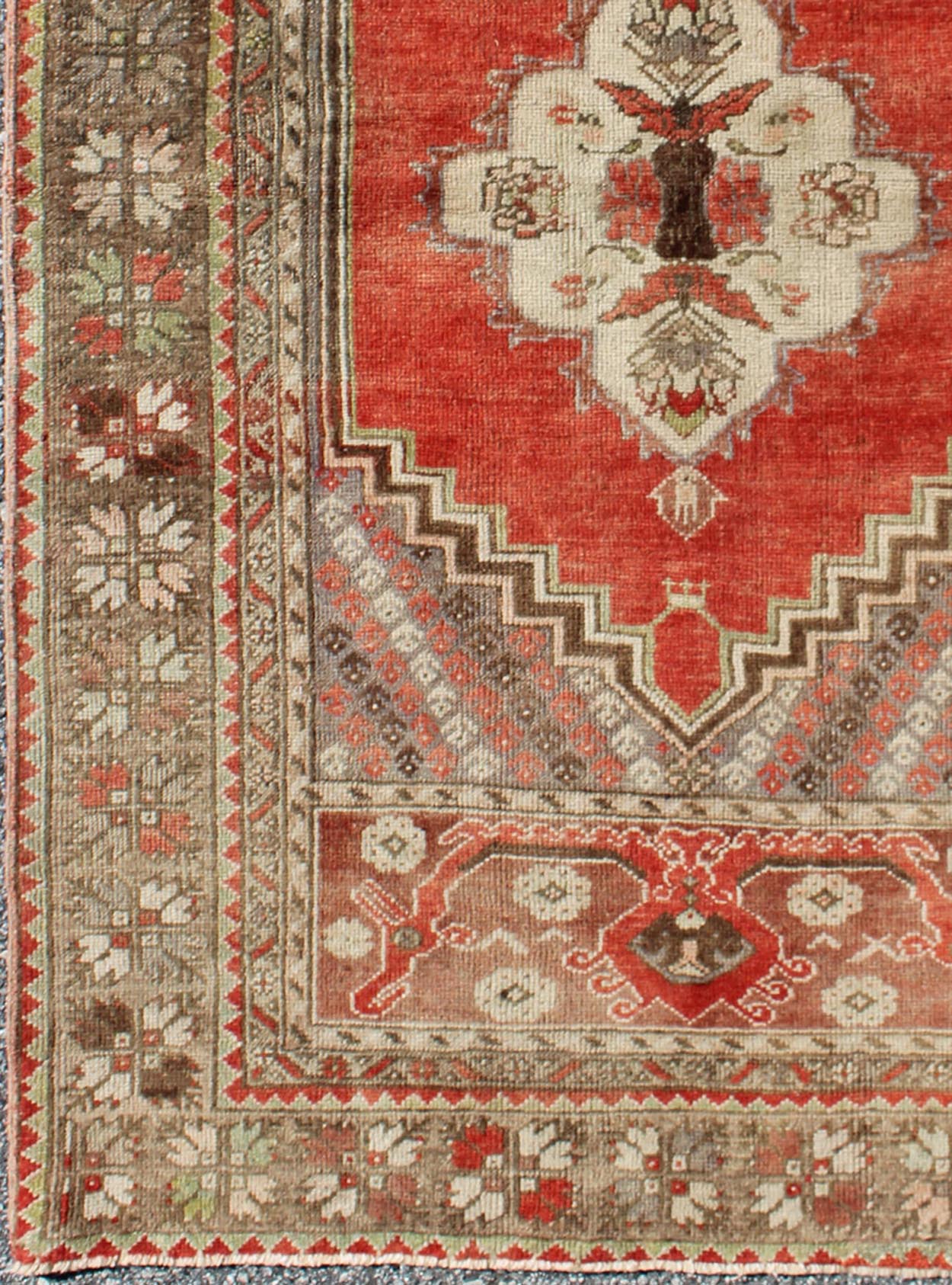 This antique Oushak bears a stylized medallion that commands the center field. A broad border of repeating motifs and floral patterns enclose the entire rug. Coral and light green colors complement the light brown, sub - geometric border. Turkish... - Keivan Woven ArtsTU - TRS - 136037 - 5048Rug