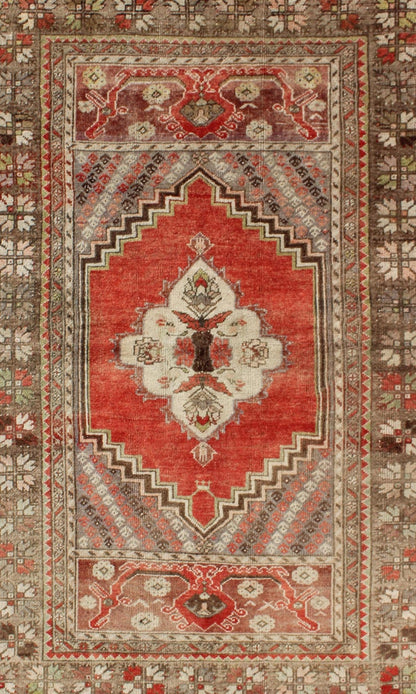 This antique Oushak bears a stylized medallion that commands the center field. A broad border of repeating motifs and floral patterns enclose the entire rug. Coral and light green colors complement the light brown, sub - geometric border. Turkish... - Keivan Woven ArtsTU - TRS - 136037 - 5048Rug
