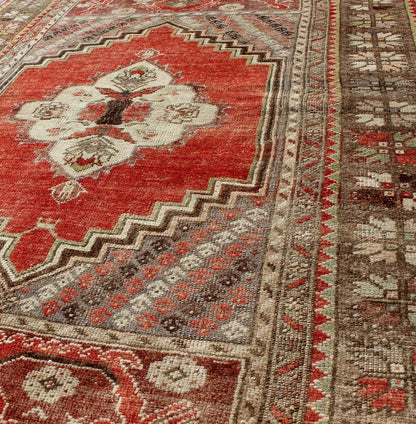 This antique Oushak bears a stylized medallion that commands the center field. A broad border of repeating motifs and floral patterns enclose the entire rug. Coral and light green colors complement the light brown, sub - geometric border. Turkish... - Keivan Woven ArtsTU - TRS - 136037 - 5048Rug