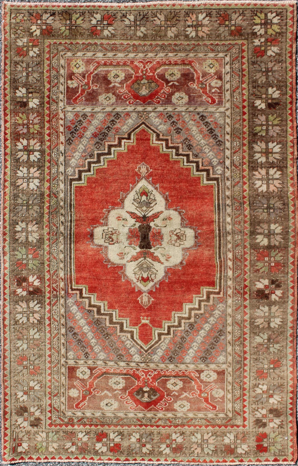 This antique Oushak bears a stylized medallion that commands the center field. A broad border of repeating motifs and floral patterns enclose the entire rug. Coral and light green colors complement the light brown, sub - geometric border. Turkish... - Keivan Woven ArtsTU - TRS - 136037 - 5048Rug