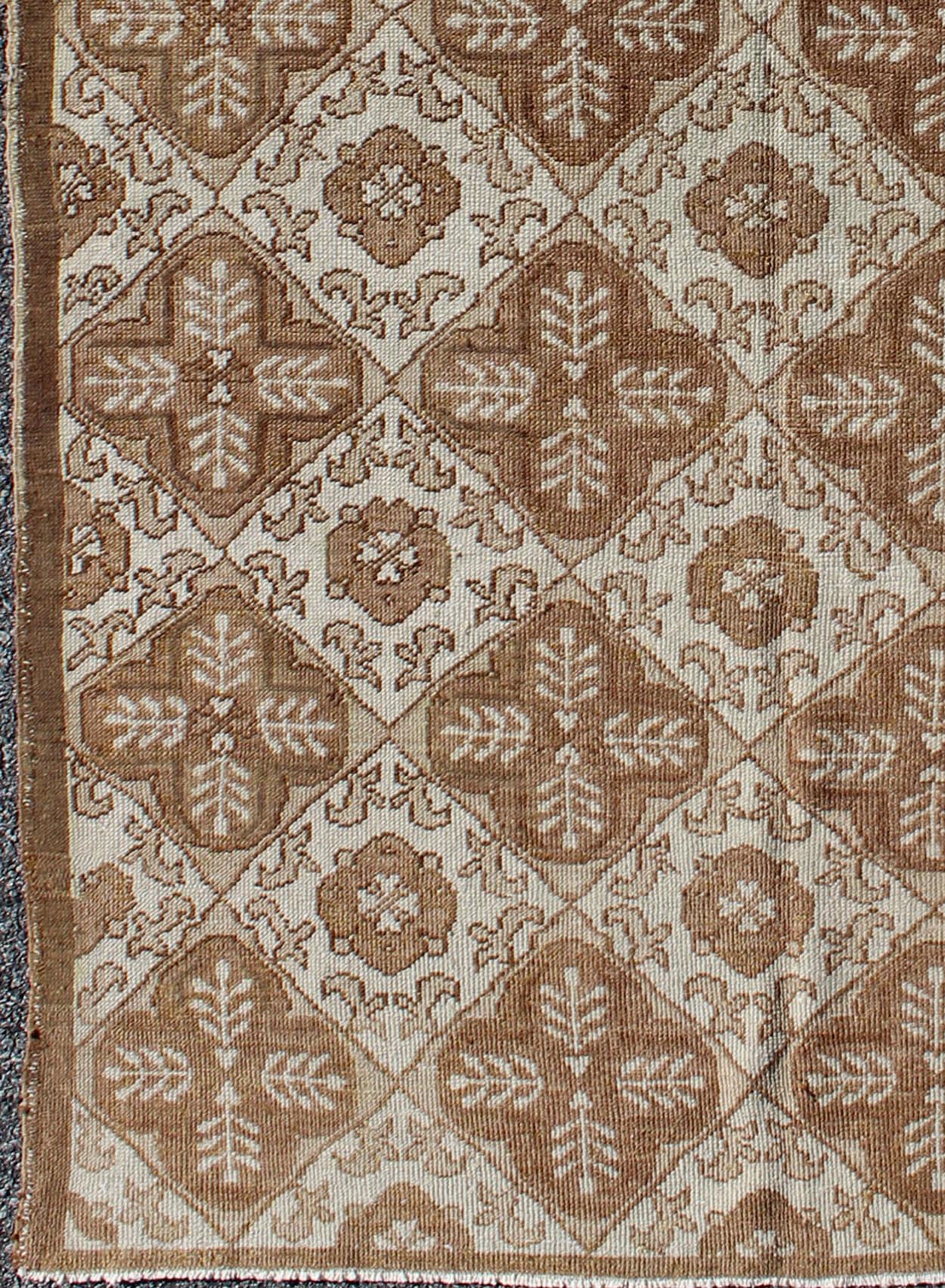 All - Over Blossom and Palmette Design Vintage Turkish Oushak Rug in Brown Tones Measures: 4'4 x 7'7. This Oushak carpet (circa mid - 20th century) features an all - over pattern of interconnected, vertically - arranged blossom and palmette motif... - Keivan Woven ArtsTU - TRS - 3254 - 6201Rug