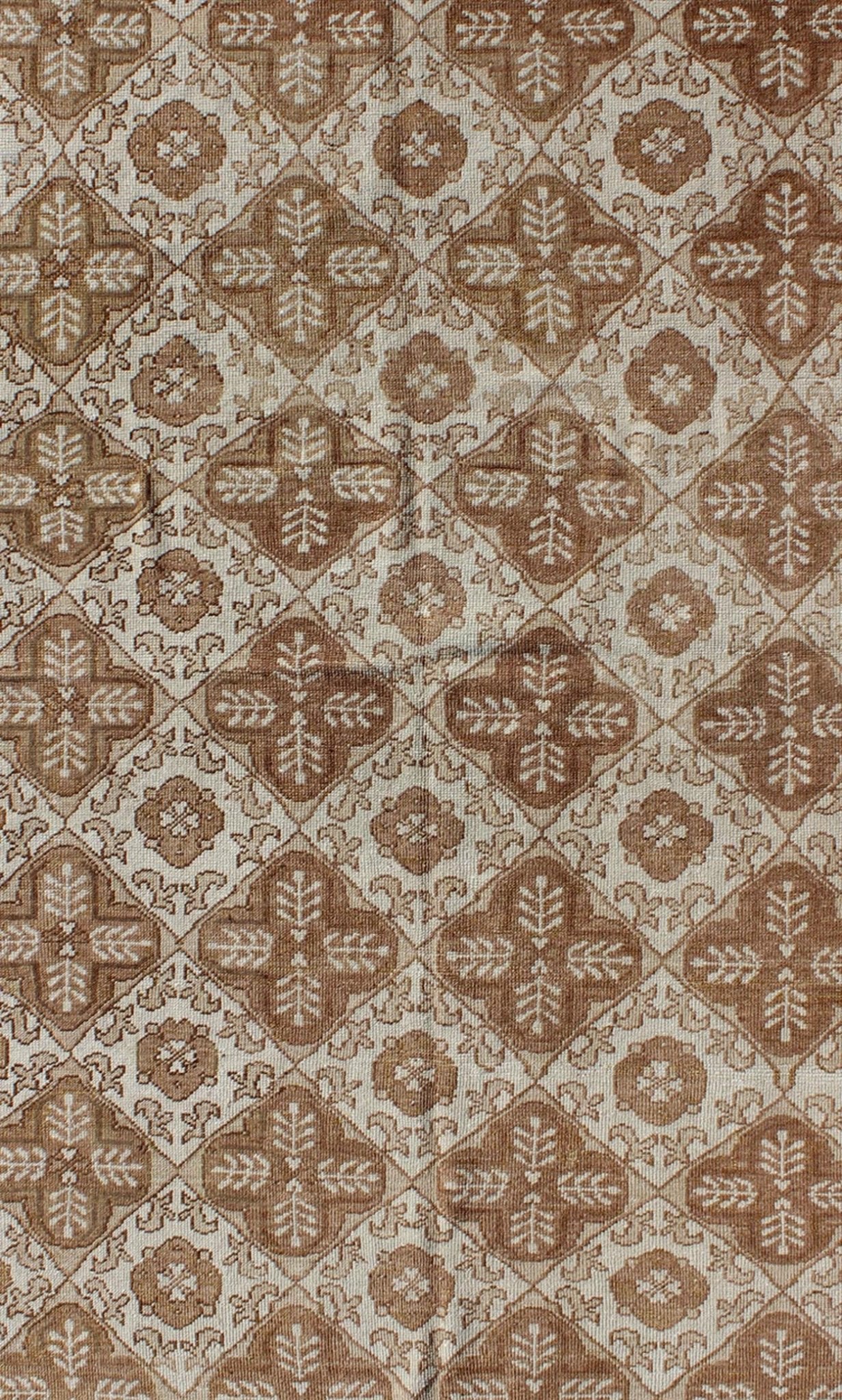 All - Over Blossom and Palmette Design Vintage Turkish Oushak Rug in Brown Tones Measures: 4'4 x 7'7. This Oushak carpet (circa mid - 20th century) features an all - over pattern of interconnected, vertically - arranged blossom and palmette motif... - Keivan Woven ArtsTU - TRS - 3254 - 6201Rug
