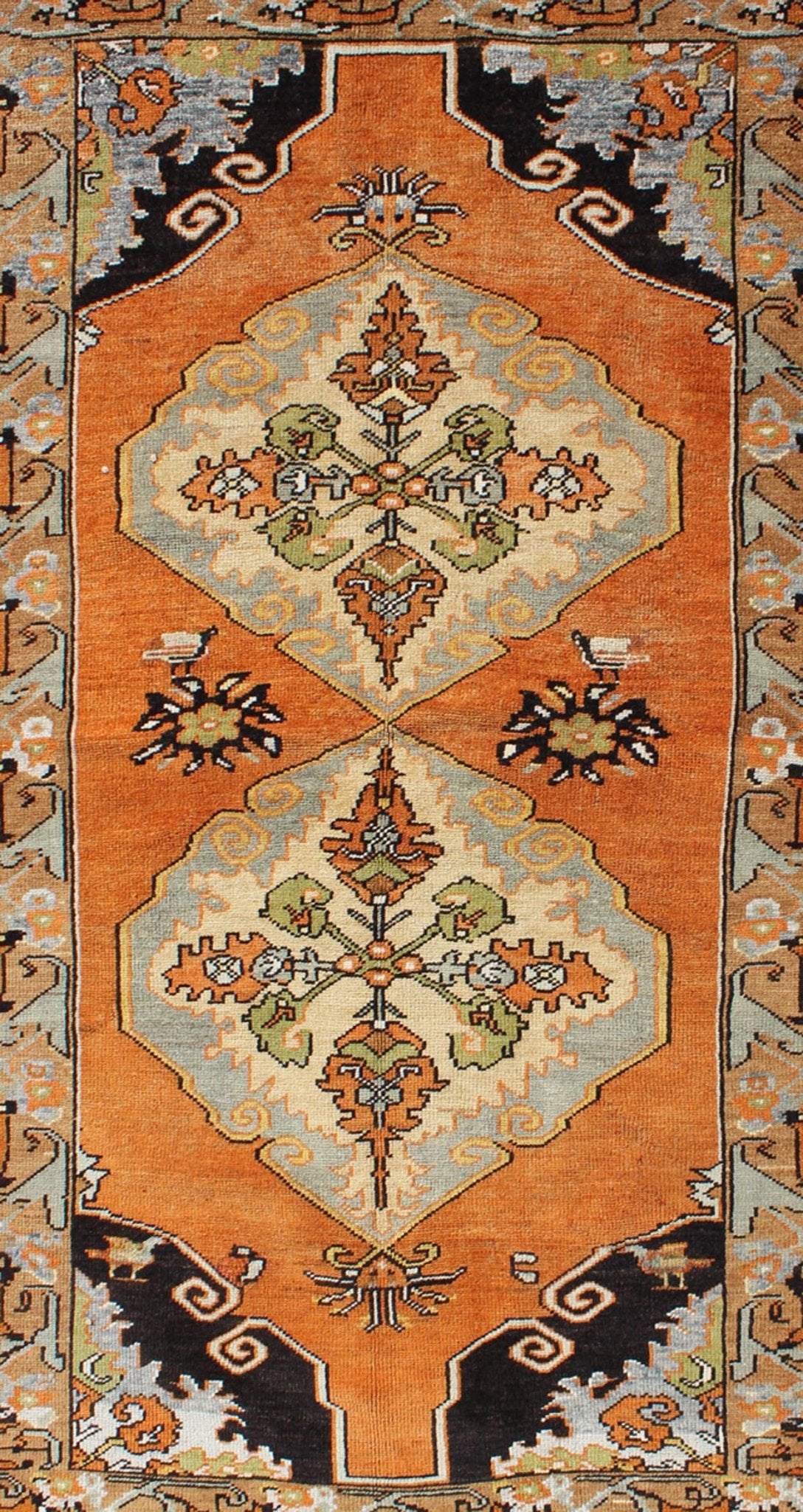 Vintage Turkish Tribal Medallion Area Rug in Orange, Green, Brown, and Blue Measures: 3'9 x 6'5 This vibrantly colored Turkish Oushak features two medallions and a highly detailed design set on an orange background with dark brown and lig... - Keivan Woven ArtsTU - TRS - 3259 - 5848Rug