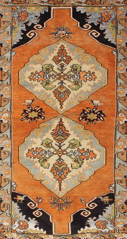 Vintage Turkish Tribal Medallion Area Rug in Orange, Green, Brown, and Blue Measures: 3'9 x 6'5 This vibrantly colored Turkish Oushak features two medallions and a highly detailed design set on an orange background with dark brown and lig... - Keivan Woven ArtsTU - TRS - 3259 - 5848Rug