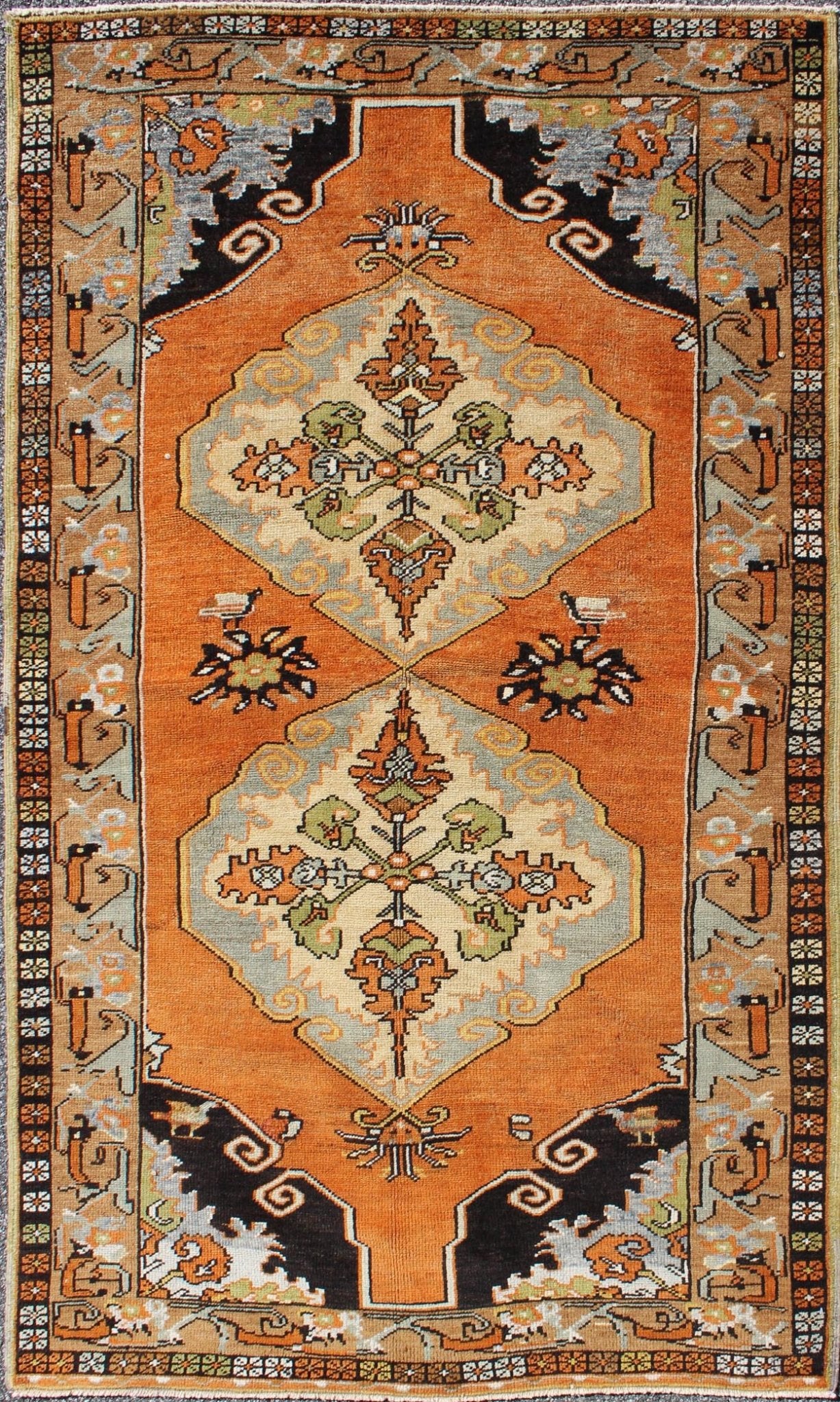 Vintage Turkish Tribal Medallion Area Rug in Orange, Green, Brown, and Blue Measures: 3'9 x 6'5 This vibrantly colored Turkish Oushak features two medallions and a highly detailed design set on an orange background with dark brown and lig... - Keivan Woven ArtsTU - TRS - 3259 - 5848Rug
