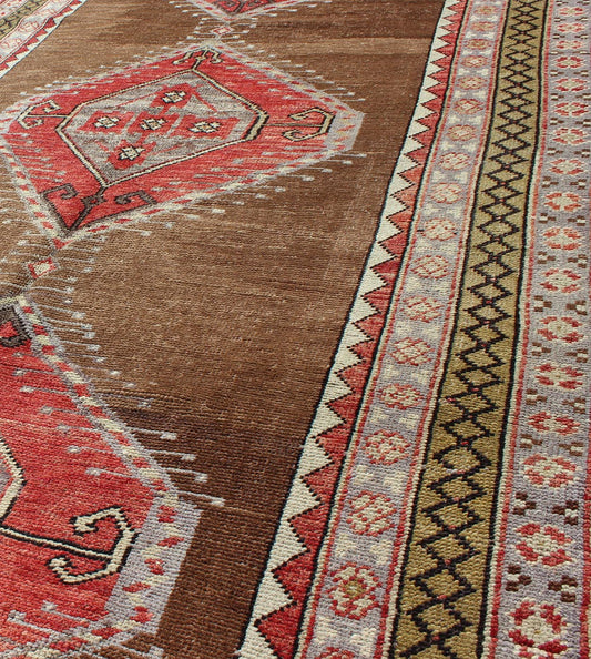 Vintage Turkish Oushak Rug with Three Large Medallions and Multiple Borders This beautiful vintage Oushak runner from mid - 20th century Turkey features a Classic Oushak design, which is enhanced by its lustrous wool. The faint brown ground is hom... - Keivan Woven ArtsTU - TRS - 3432 - 5920Rug