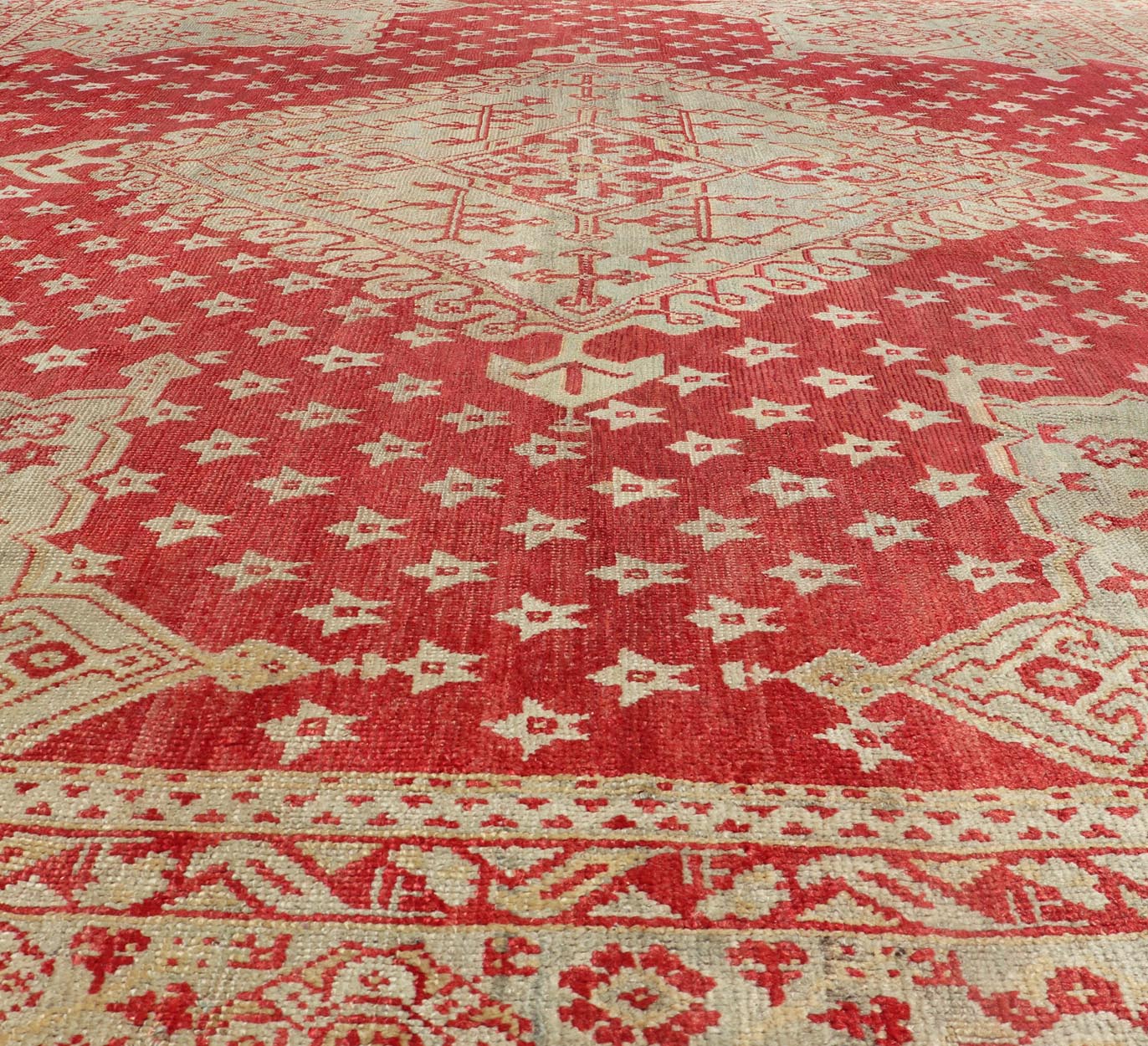 Antique Turkish Oushak rug in delicate red background and light blue border, Rug / TU - TRS - 3472, Antique Oushak Circa 1910 This lovely antique Oushak showcases an elegant medallion design with four cornices that hold the field. The background... - Keivan Woven ArtsTU - TRS - 3472 - 6919Rug