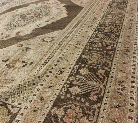 Measures: 6.1 x 9.8 Set on a muddy green background, this vintage Turkish Oushak displays a rustic diamond medallion decorated with vines and flora. The darker border homes similar stylizations of floral motifs commonly seen with Oushaks from th... - Keivan Woven ArtsTU - TRS - 95003 - 3880Rug
