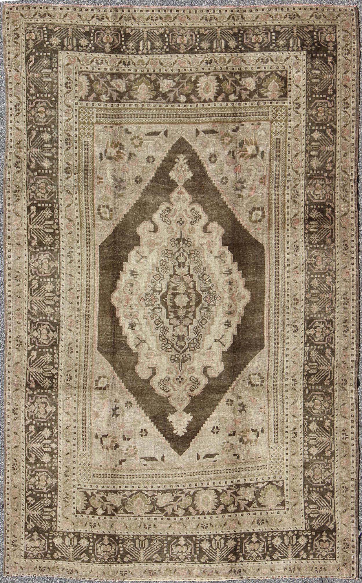 Measures: 6.1 x 9.8 Set on a muddy green background, this vintage Turkish Oushak displays a rustic diamond medallion decorated with vines and flora. The darker border homes similar stylizations of floral motifs commonly seen with Oushaks from th... - Keivan Woven ArtsTU - TRS - 95003 - 3880Rug