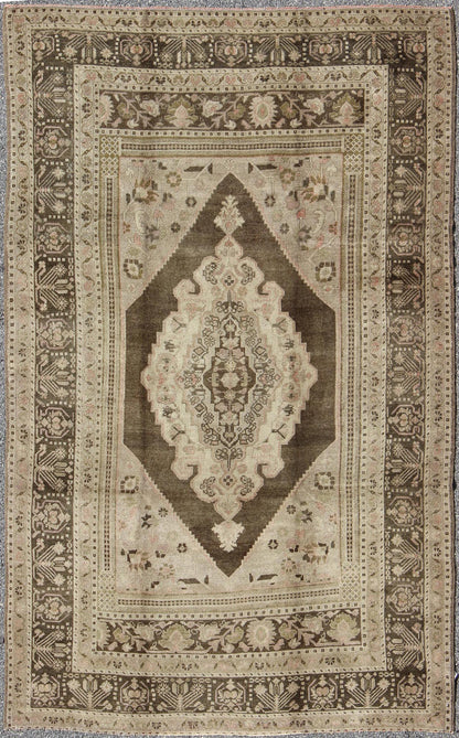 Measures: 6.1 x 9.8 Set on a muddy green background, this vintage Turkish Oushak displays a rustic diamond medallion decorated with vines and flora. The darker border homes similar stylizations of floral motifs commonly seen with Oushaks from th... - Keivan Woven ArtsTU - TRS - 95003 - 3880Rug