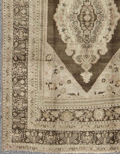 Measures: 6.1 x 9.8 Set on a muddy green background, this vintage Turkish Oushak displays a rustic diamond medallion decorated with vines and flora. The darker border homes similar stylizations of floral motifs commonly seen with Oushaks from th... - Keivan Woven ArtsTU - TRS - 95003 - 3880Rug