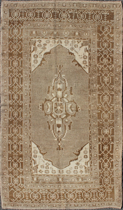 Vintage Turkish Medallion Oushak Area Rug in Grey and Brown's Measures: 3.10 x 6.10 Set amidst a taupe and gray background and featuring a gentle medallion, the beautiful and delicate design of this rug is framed by repeating geometric el... - Keivan Woven ArtsTU - TRS - 95020 - 3582Rug
