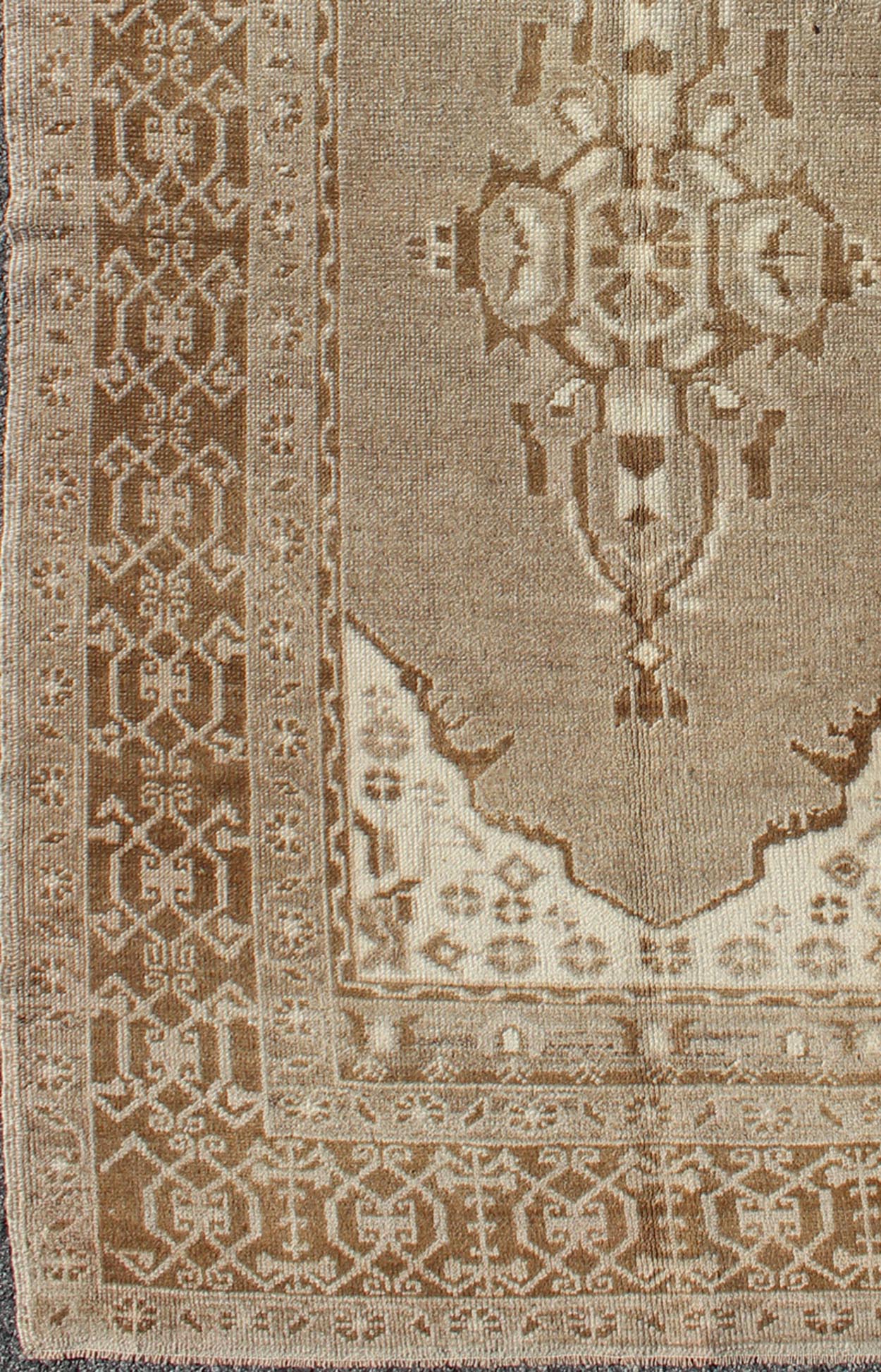 Vintage Turkish Medallion Oushak Area Rug in Grey and Brown's Measures: 3.10 x 6.10 Set amidst a taupe and gray background and featuring a gentle medallion, the beautiful and delicate design of this rug is framed by repeating geometric el... - Keivan Woven ArtsTU - TRS - 95020 - 3582Rug