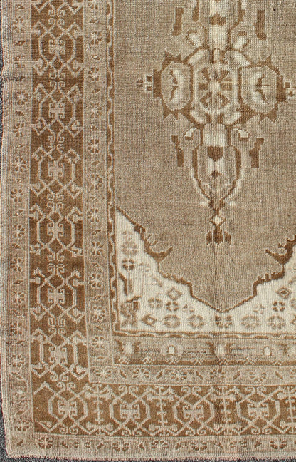 Vintage Turkish Medallion Oushak Area Rug in Grey and Brown's Measures: 3.10 x 6.10 Set amidst a taupe and gray background and featuring a gentle medallion, the beautiful and delicate design of this rug is framed by repeating geometric el... - Keivan Woven ArtsTU - TRS - 95020 - 3582Rug