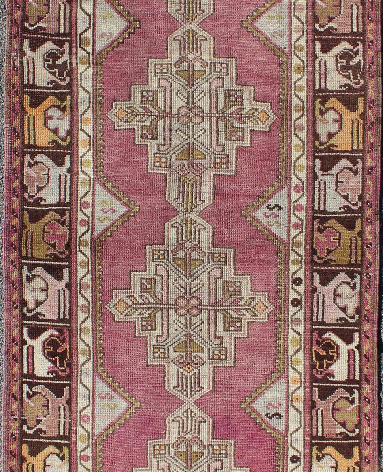 Vintage Oushak Runner This unusual Oushak bears a remarkable geometric design that is complemented by a delicately understated color palette. The purple background plays host to an intriguing display of muted geometric patterns in hues of pale a... - Keivan Woven ArtsTU - TRS - 95151 - 5040Rug