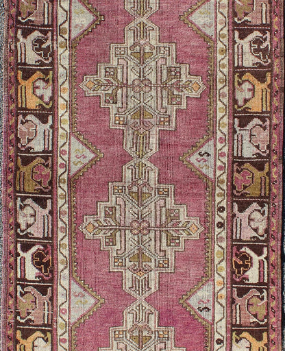 Vintage Oushak Runner This unusual Oushak bears a remarkable geometric design that is complemented by a delicately understated color palette. The purple background plays host to an intriguing display of muted geometric patterns in hues of pale a... - Keivan Woven ArtsTU - TRS - 95151 - 5040Rug