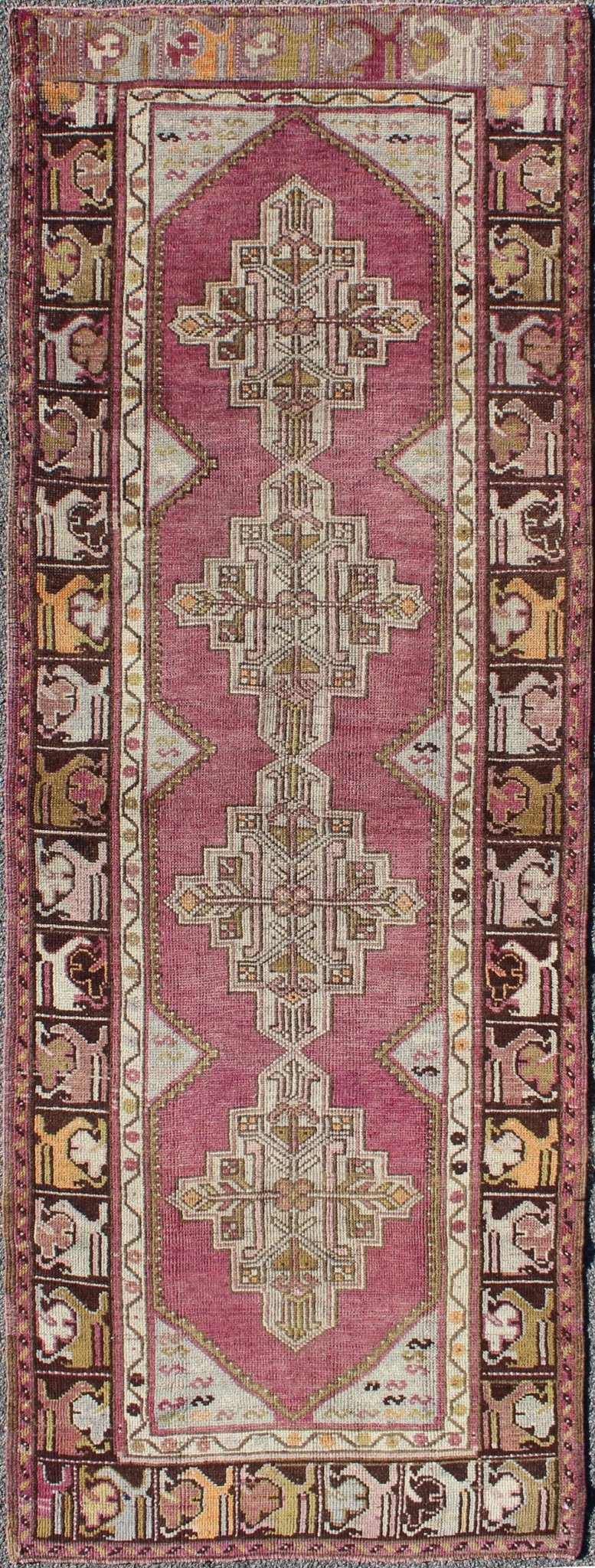 Vintage Oushak Runner This unusual Oushak bears a remarkable geometric design that is complemented by a delicately understated color palette. The purple background plays host to an intriguing display of muted geometric patterns in hues of pale a... - Keivan Woven ArtsTU - TRS - 95151 - 5040Rug