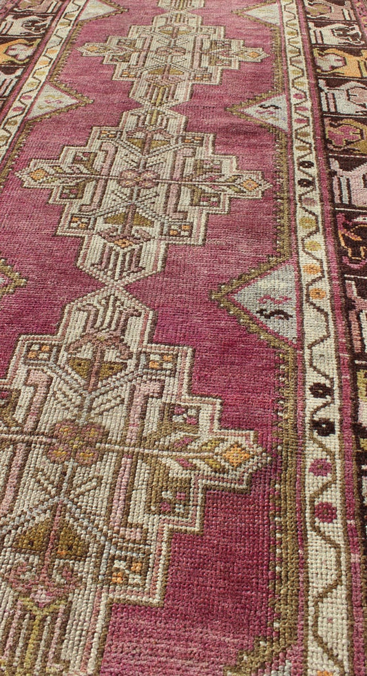 Vintage Oushak Runner This unusual Oushak bears a remarkable geometric design that is complemented by a delicately understated color palette. The purple background plays host to an intriguing display of muted geometric patterns in hues of pale a... - Keivan Woven ArtsTU - TRS - 95151 - 5040