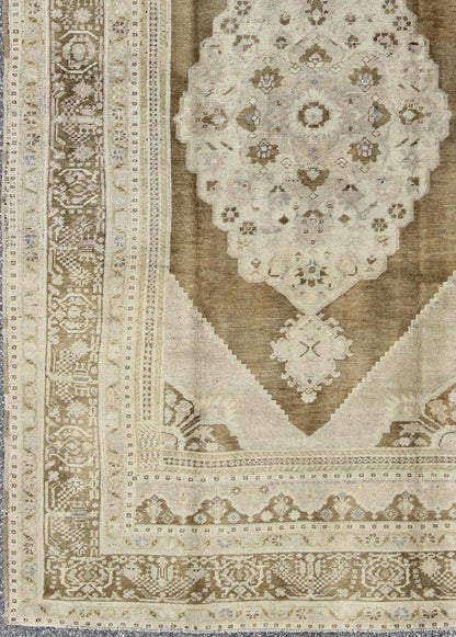 Vintage Turkish Floral Medallion Oushak Rug in Khaki and Brown Tones Measures: 5'11 x 9'6 Set on a khaki background and brown border, this vintage Turkish Oushak displays an unique earth tone color combination with various shades of taupe... - Keivan Woven ArtsTU - UGU - 11 - 3126Rug