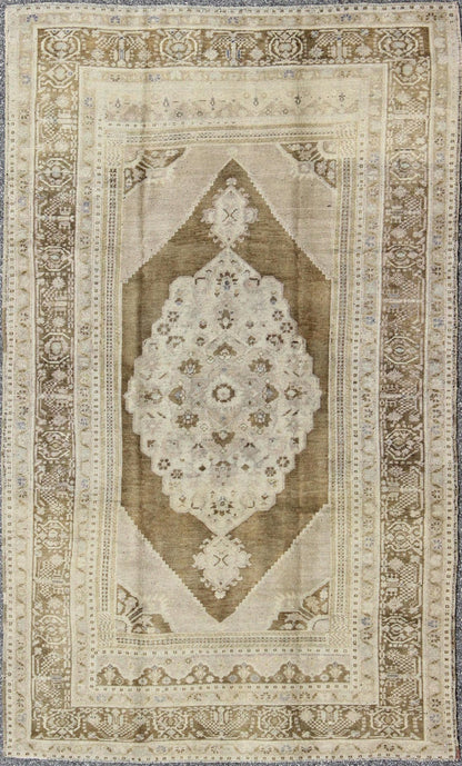 Vintage Turkish Floral Medallion Oushak Rug in Khaki and Brown Tones Measures: 5'11 x 9'6 Set on a khaki background and brown border, this vintage Turkish Oushak displays an unique earth tone color combination with various shades of taupe... - Keivan Woven ArtsTU - UGU - 11 - 3126Rug