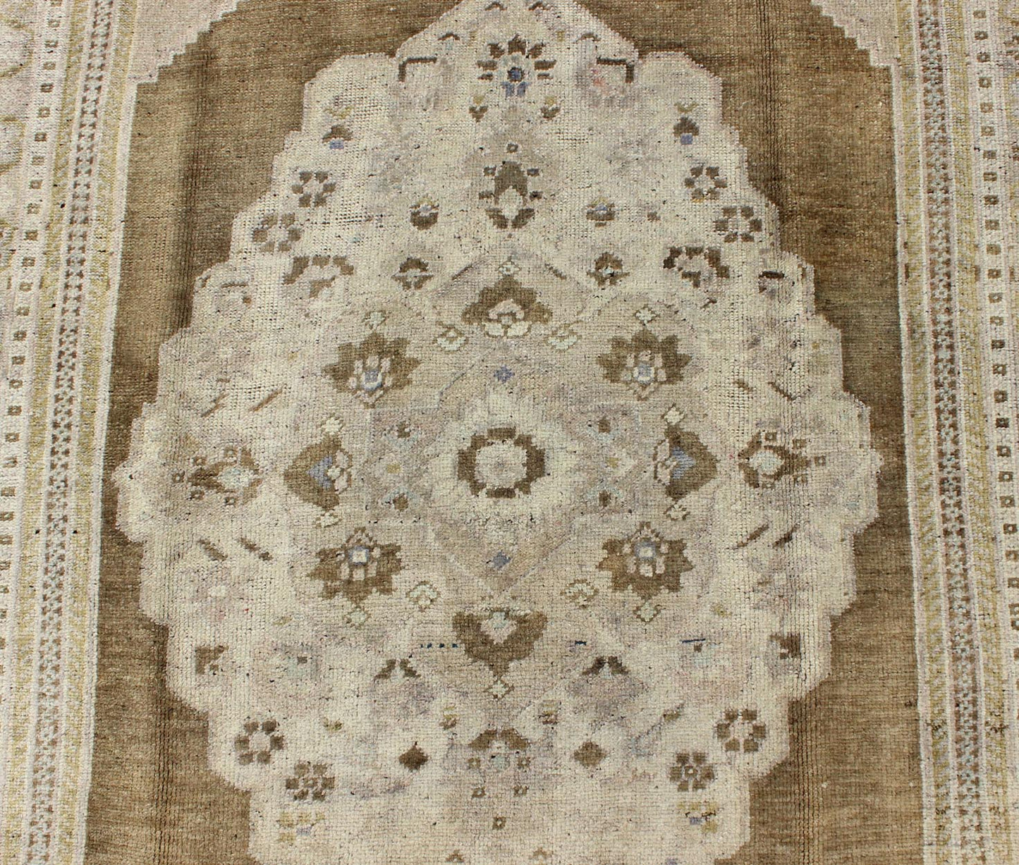 Vintage Turkish Floral Medallion Oushak Rug in Khaki and Brown Tones Measures: 5'11 x 9'6 Set on a khaki background and brown border, this vintage Turkish Oushak displays an unique earth tone color combination with various shades of taupe... - Keivan Woven ArtsTU - UGU - 11 - 3126Rug