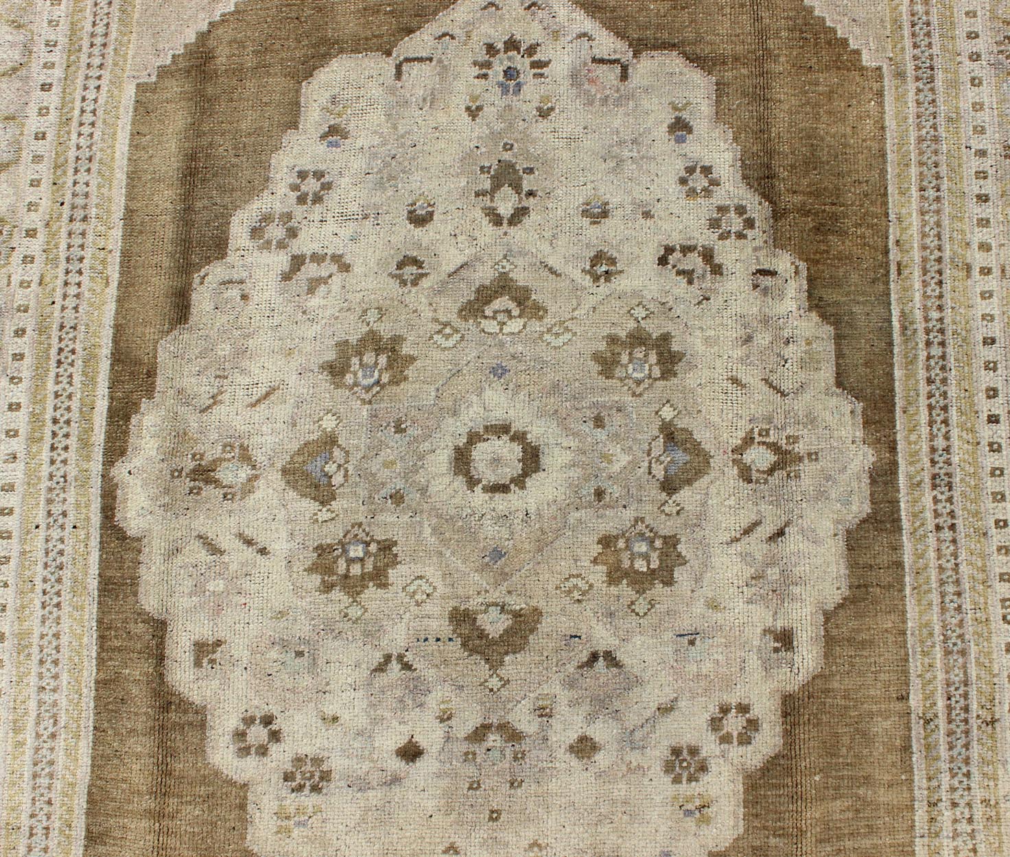Vintage Turkish Floral Medallion Oushak Rug in Khaki and Brown Tones Measures: 5'11 x 9'6 Set on a khaki background and brown border, this vintage Turkish Oushak displays an unique earth tone color combination with various shades of taupe... - Keivan Woven ArtsTU - UGU - 11 - 3126Rug