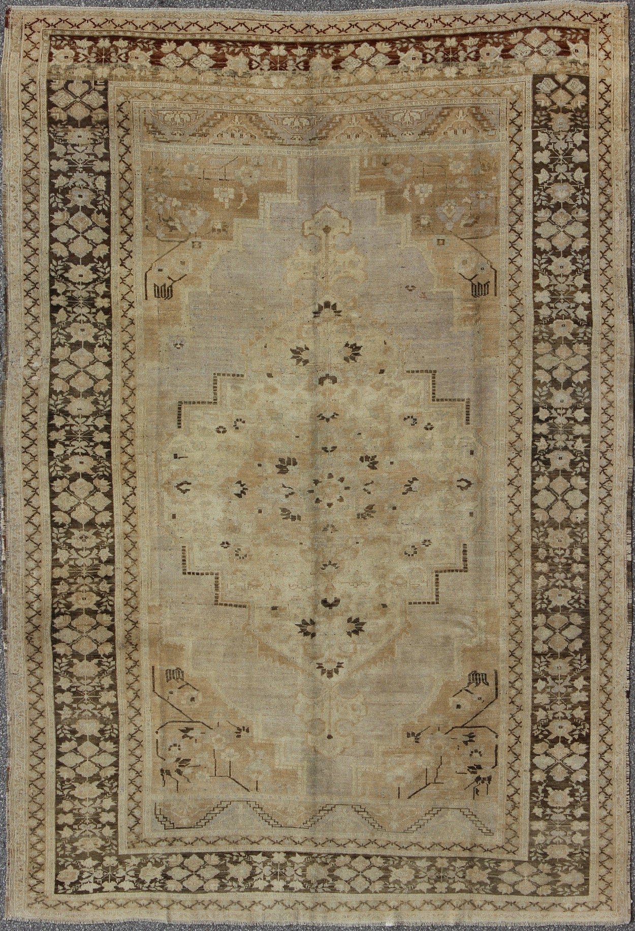 Vintage Turkish Floral Medallion Oushak Area Rug in Tan, Brown and Beige Measures: 7'11 x 11'5 This Vintage Turkish Oushak, from 1940s Turkey, featuring a chocolate brown border with connecting flower and vines. The sandy field combines ... - Keivan Woven ArtsTU - UGU - 14 - 3100Rug