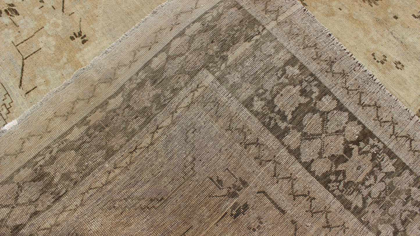 Vintage Turkish Floral Medallion Oushak Area Rug in Tan, Brown and Beige Measures: 7'11 x 11'5 This Vintage Turkish Oushak, from 1940s Turkey, featuring a chocolate brown border with connecting flower and vines. The sandy field combines ... - Keivan Woven ArtsTU - UGU - 14 - 3100Rug