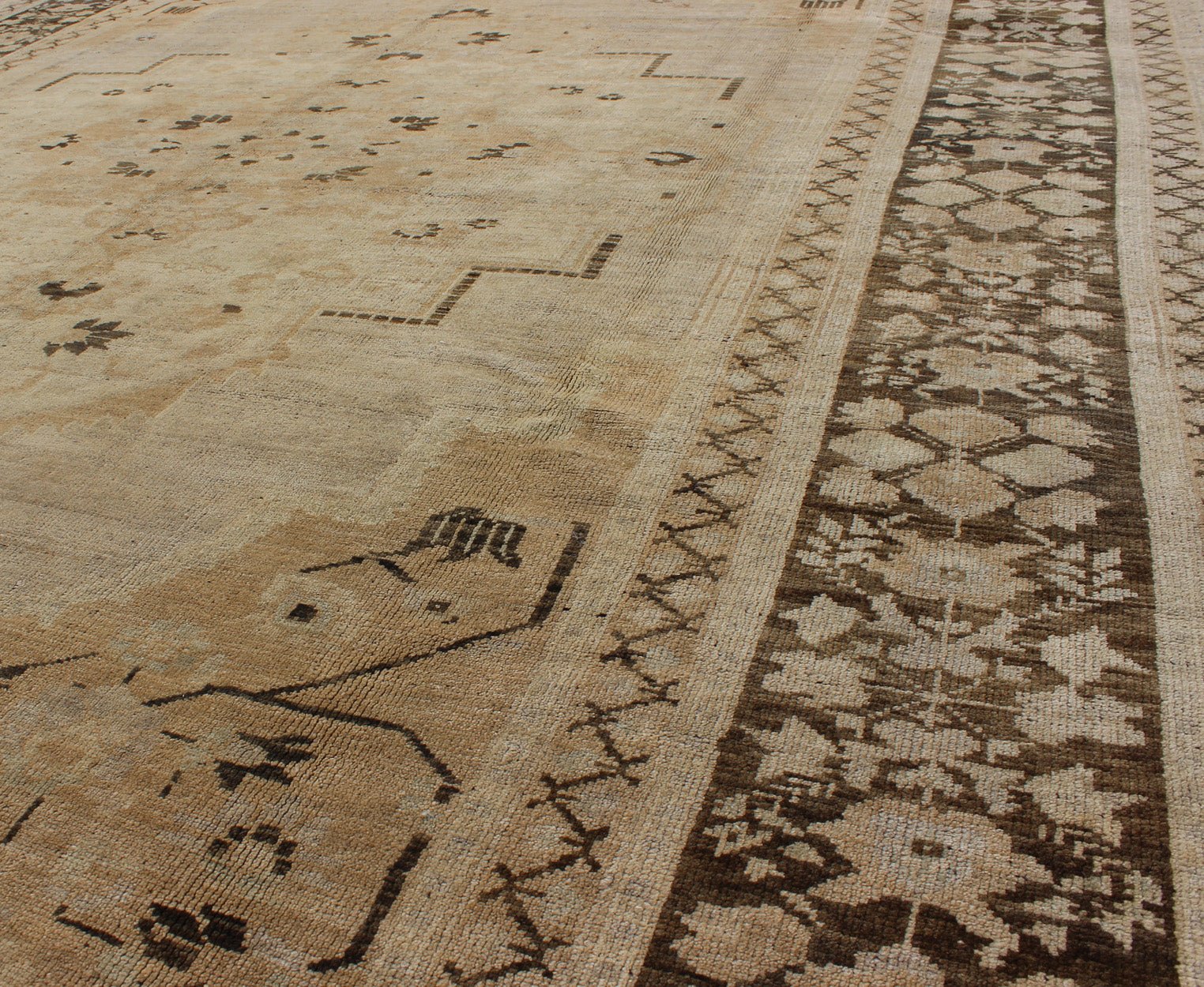 Vintage Turkish Floral Medallion Oushak Area Rug in Tan, Brown and Beige Measures: 7'11 x 11'5 This Vintage Turkish Oushak, from 1940s Turkey, featuring a chocolate brown border with connecting flower and vines. The sandy field combines ... - Keivan Woven ArtsTU - UGU - 14 - 3100Rug