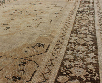 Vintage Turkish Floral Medallion Oushak Area Rug in Tan, Brown and Beige Measures: 7'11 x 11'5 This Vintage Turkish Oushak, from 1940s Turkey, featuring a chocolate brown border with connecting flower and vines. The sandy field combines ... - Keivan Woven ArtsTU - UGU - 14 - 3100Rug