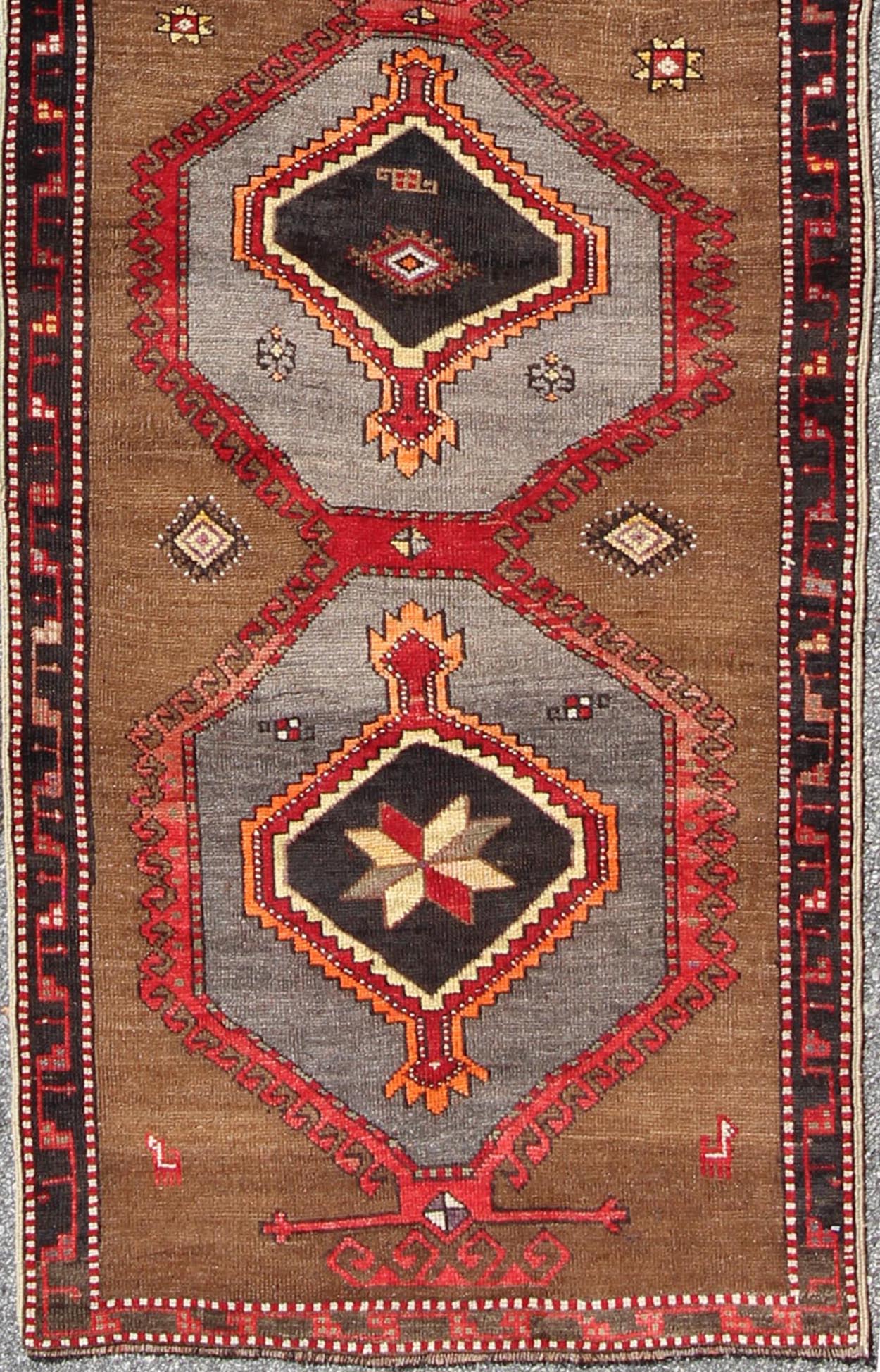 Geometric Turkish Runner with Brown This Turkish runner boasts five geometric medallions along with a unique color scheme. The light and dark shades of brown in the background surround the multi - diamond shaped geometric medallions. The multi - col... - Keivan Woven ArtsTU - UGU - 3337 - 5876Rug