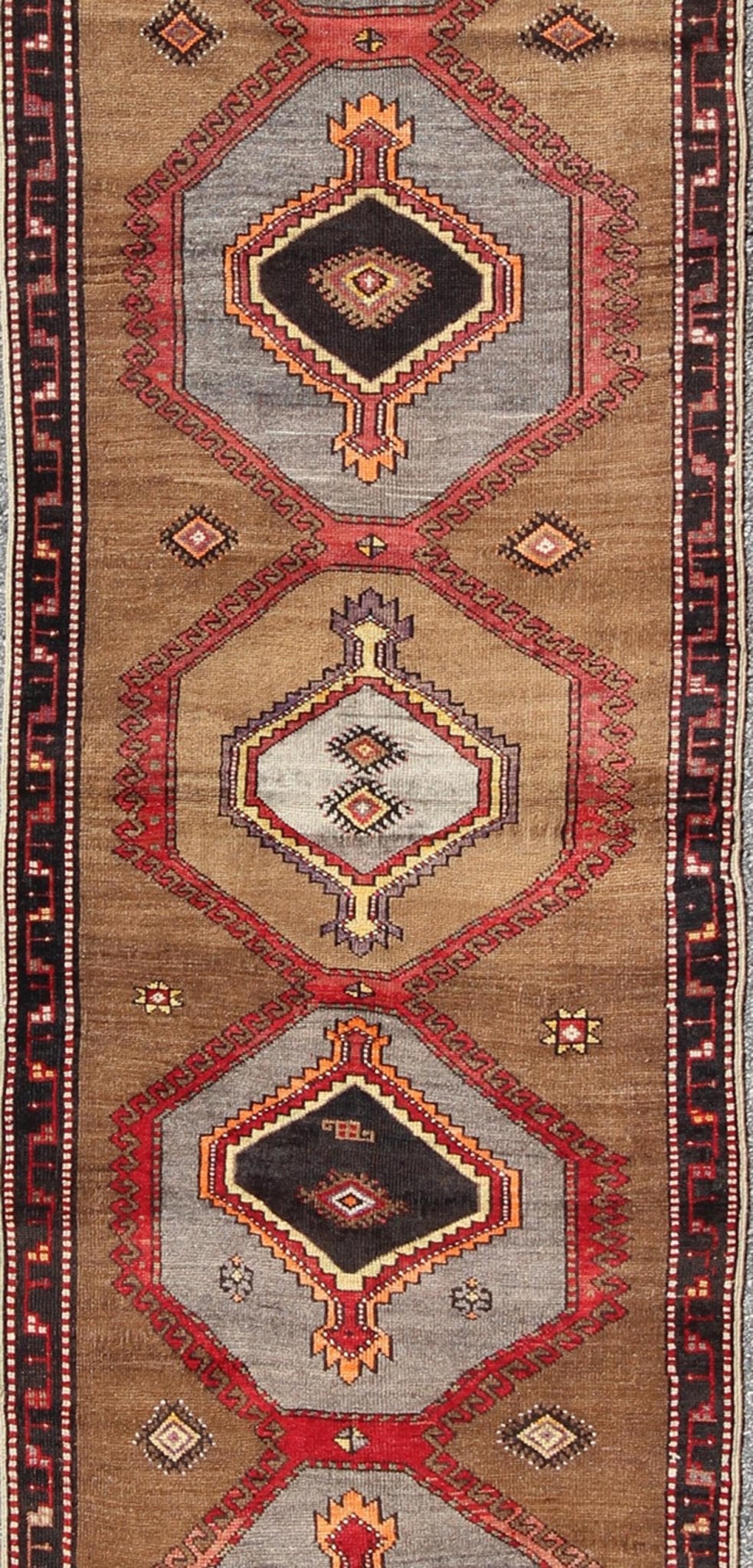 Geometric Turkish Runner with Brown This Turkish runner boasts five geometric medallions along with a unique color scheme. The light and dark shades of brown in the background surround the multi - diamond shaped geometric medallions. The multi - col... - Keivan Woven ArtsTU - UGU - 3337 - 5876Rug