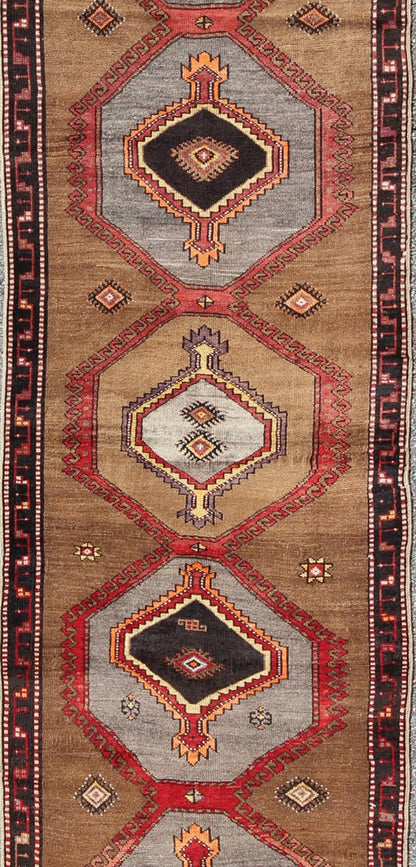 Geometric Turkish Runner with Brown This Turkish runner boasts five geometric medallions along with a unique color scheme. The light and dark shades of brown in the background surround the multi - diamond shaped geometric medallions. The multi - col... - Keivan Woven ArtsTU - UGU - 3337 - 5876Rug