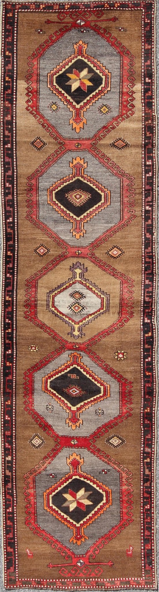 Geometric Turkish Runner with Brown This Turkish runner boasts five geometric medallions along with a unique color scheme. The light and dark shades of brown in the background surround the multi - diamond shaped geometric medallions. The multi - col... - Keivan Woven ArtsTU - UGU - 3337 - 5876Rug