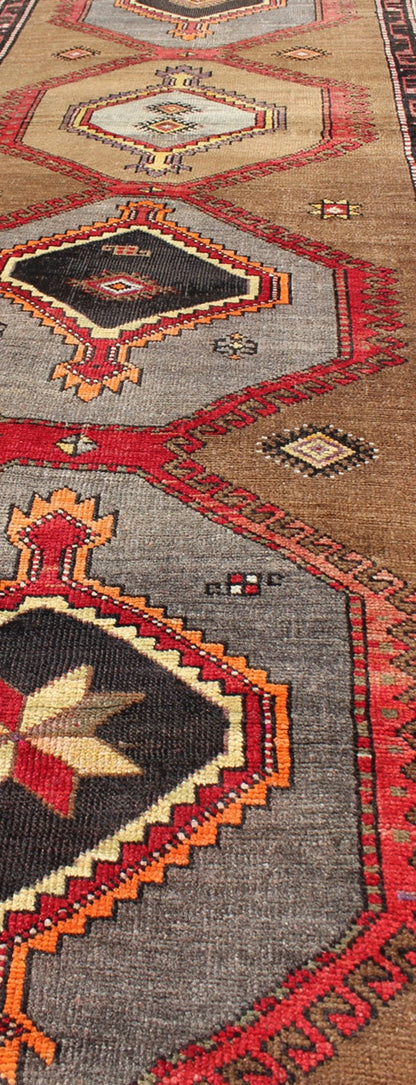 Geometric Turkish Runner with Brown This Turkish runner boasts five geometric medallions along with a unique color scheme. The light and dark shades of brown in the background surround the multi - diamond shaped geometric medallions. The multi - col... - Keivan Woven ArtsTU - UGU - 3337 - 5876Rug