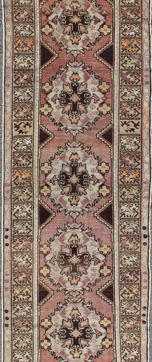 Vintage Turkish Oushak Runner with Floral Medallions in Brown Lavender and Taupe Measures: 2'11'' x 9'8''. This beautiful vintage Oushak runner from 1940s Turkey features a Classic Oushak design. The reddish - colored ground is home to intercon... - Keivan Woven ArtsTU - UGU - 3482 - 6933Rug