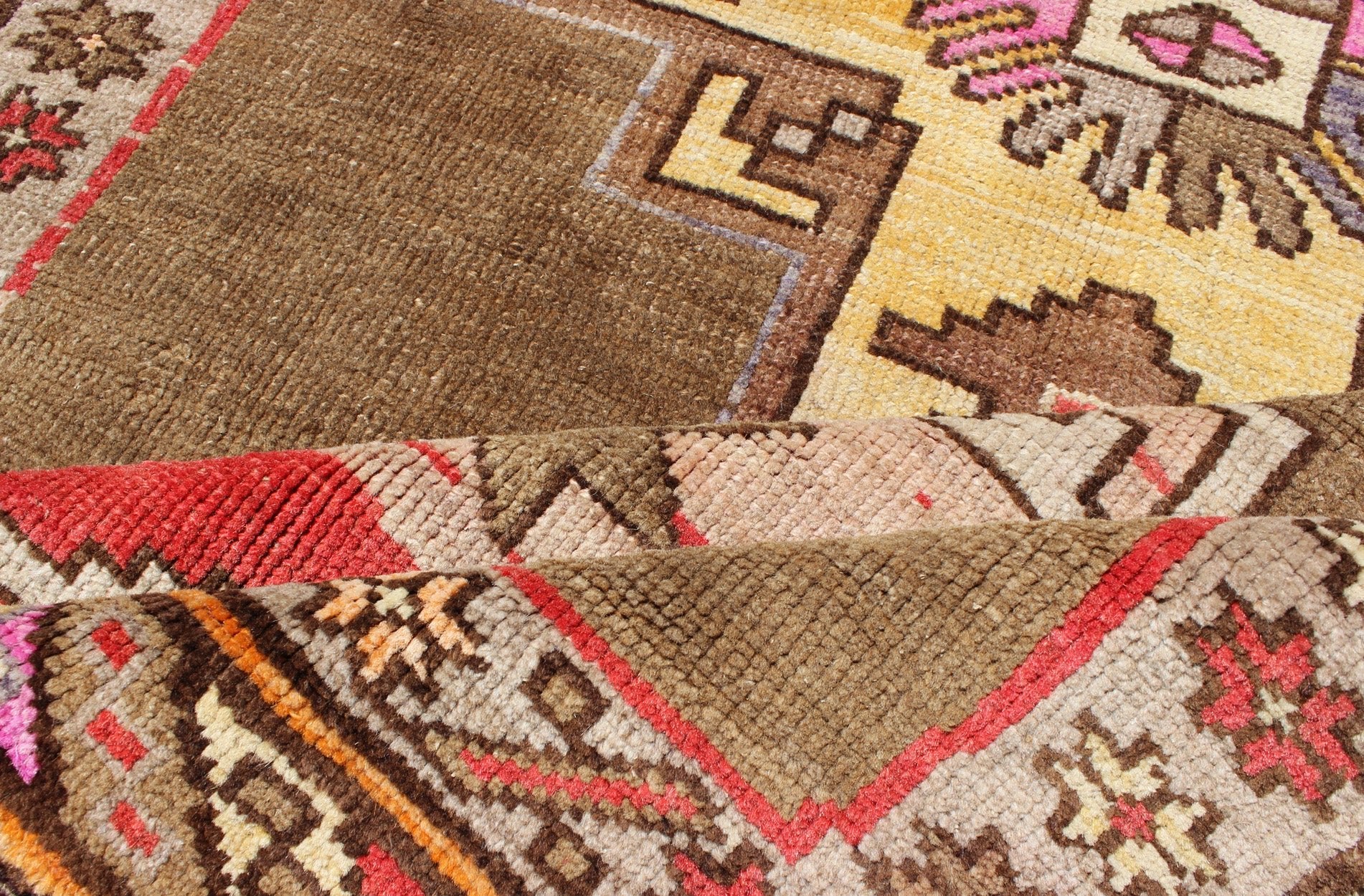 Unique & Colorful Turkish Kars Runner with Tribal Designs and Geometric Motifs Vintage Turkish runner in greenish Brown background, ivory border with accent colors, red, pink, tan, green, bright yellow, taupe, rug/TU - UGU - 4806, country of origin... - Keivan Woven ArtsTU - UGU - 4806 - 10287Rug
