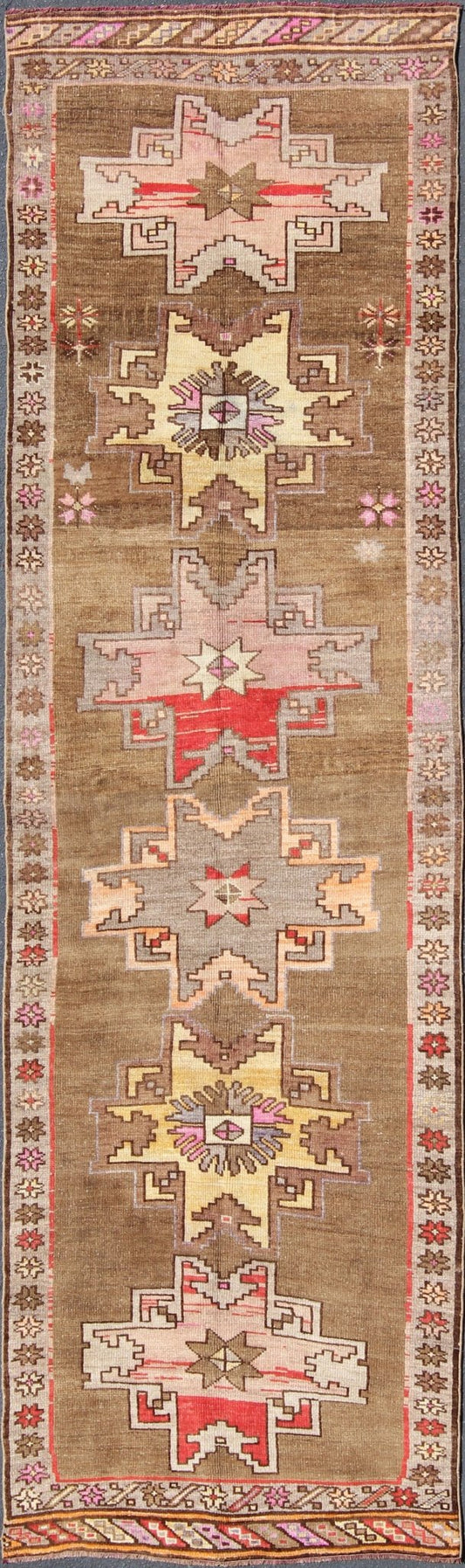 Unique & Colorful Turkish Kars Runner with Tribal Designs and Geometric Motifs Vintage Turkish runner in greenish Brown background, ivory border with accent colors, red, pink, tan, green, bright yellow, taupe, rug/TU - UGU - 4806, country of origin... - Keivan Woven ArtsTU - UGU - 4806 - 10287