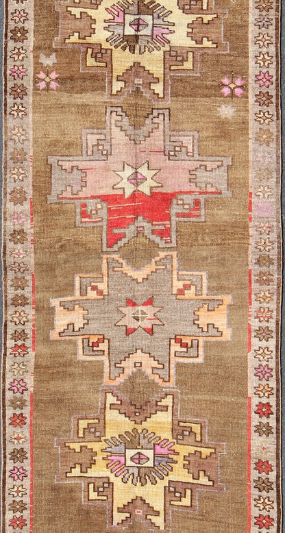 Unique & Colorful Turkish Kars Runner with Tribal Designs and Geometric Motifs Vintage Turkish runner in greenish Brown background, ivory border with accent colors, red, pink, tan, green, bright yellow, taupe, rug/TU - UGU - 4806, country of origin... - Keivan Woven ArtsTU - UGU - 4806 - 10287Rug