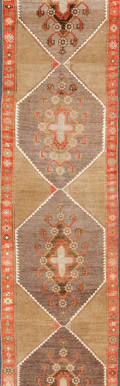 Colorful Vintage Turkish Runner with Diamond Medallions in Lt. Camel, orange and Gray Long and narrow vintage runner from Turkey with multi geometric diamond medallion design in camel background, rust, gray, orange, brown and taupe. rug/TU - UGU... - Keivan Woven ArtsTU - UGU - 4808 - 10297Rug