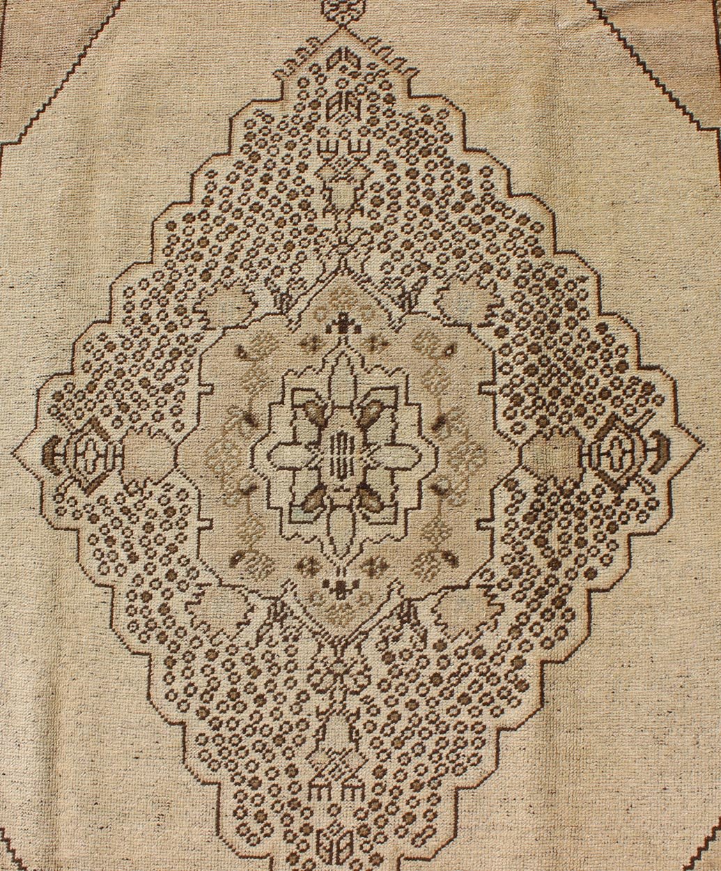 Vintage Turkish Stylized Medallion Oushak Rug in Sandy Neutrals and Earth Tones Measures: 5'7 x 10'2 This vintage Turkish Oushak sets on a neutral sandy ground with a central medallion stylized with small details. The background is ... - Keivan Woven ArtsTU - UGU - 56 - 2854Rug