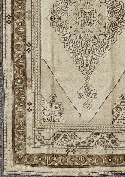 Vintage Turkish Stylized Medallion Oushak Rug in Sandy Neutrals and Earth Tones Measures: 5'7 x 10'2 This vintage Turkish Oushak sets on a neutral sandy ground with a central medallion stylized with small details. The background is ... - Keivan Woven ArtsTU - UGU - 56 - 2854Rug