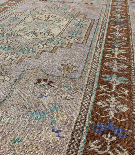 Vintage Oushak Rug in Light Lavender Background and Chocolate Brown Border. Vintage Oushak rug with central medallion in Light lavender, Taupe, Khaki, Teal green, blue accent colors and chocolate brown border. Keivan Woven Arts Rug TU - VEY - 3287,... - Keivan Woven ArtsTU - VEY - 3287 - 5910Rug