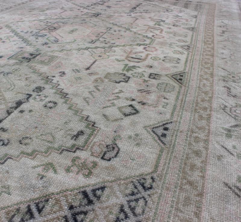 Vintage Turkish Tribal Medallion Oushak in Muted Green, Pink, and Off White Measures: 5'10 x 9'11. This vintage Turkish Oushak rug features a unique blend of colors and an intricately beautiful design. The medallions, arranged in a v... - Keivan Woven ArtsTU - VEY - 4602 - 7911Rug