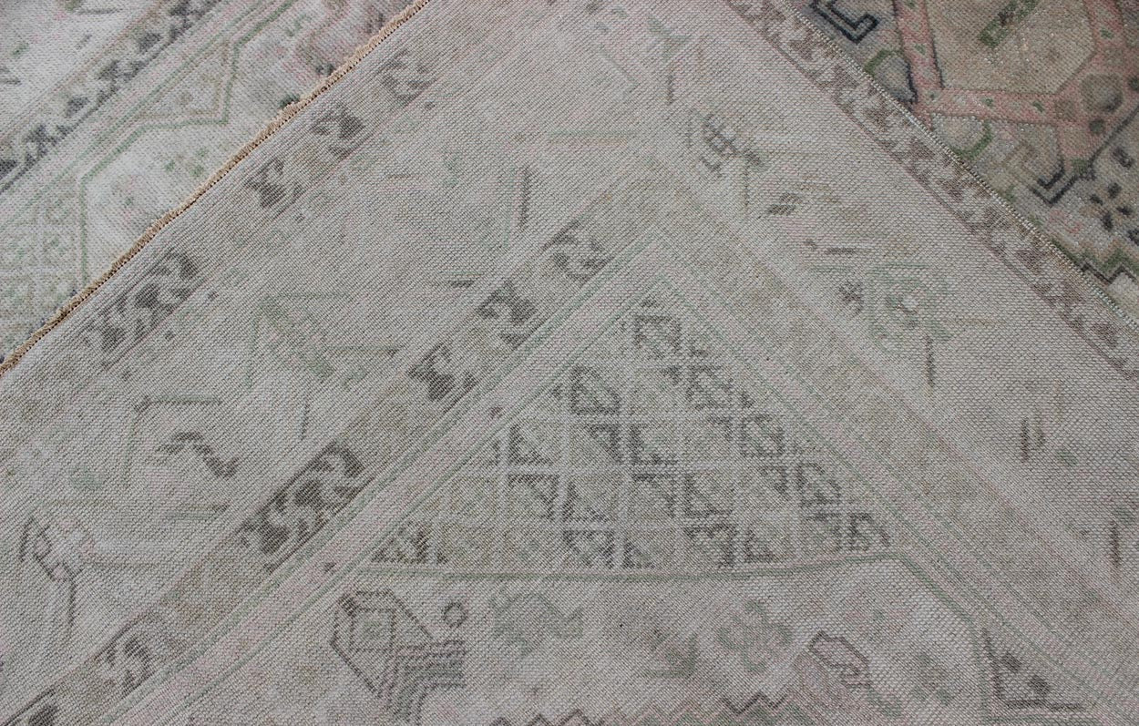 Vintage Turkish Tribal Medallion Oushak in Muted Green, Pink, and Off White Measures: 5'10 x 9'11. This vintage Turkish Oushak rug features a unique blend of colors and an intricately beautiful design. The medallions, arranged in a v... - Keivan Woven ArtsTU - VEY - 4602 - 7911Rug