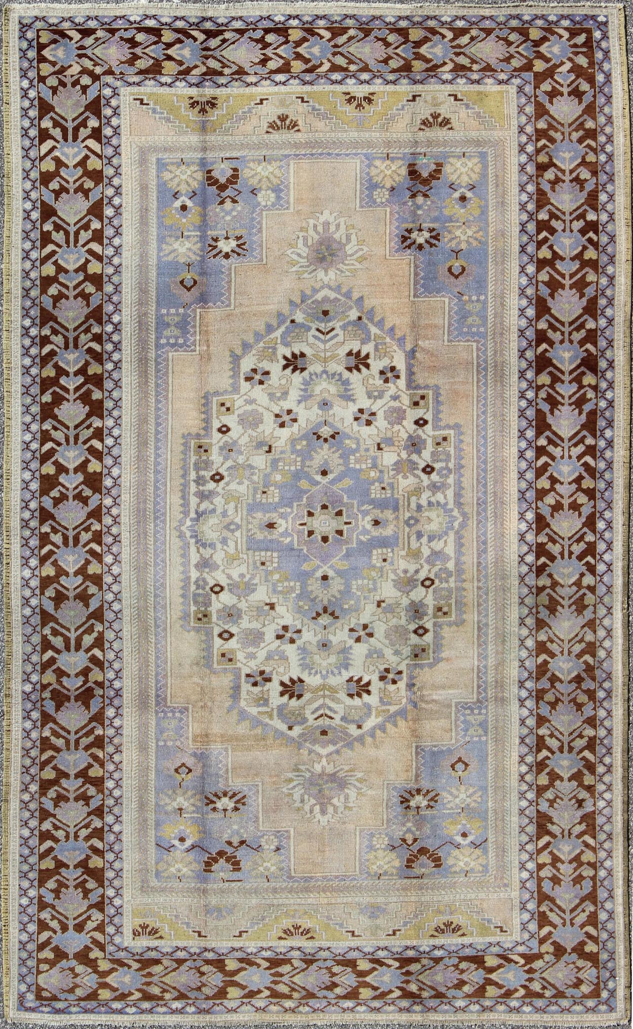 Vintage Turkish Oushak - This stunning vintage Turkish Oushak rug shows a charming combination of warm and cool colors. Set on a brown border with a pop of the same brown throughout, this unique Oushak displays light purple, cream, beige, soft yellow, gr... - Keivan Woven ArtsTU - YUN - 136075 - 4702Rug