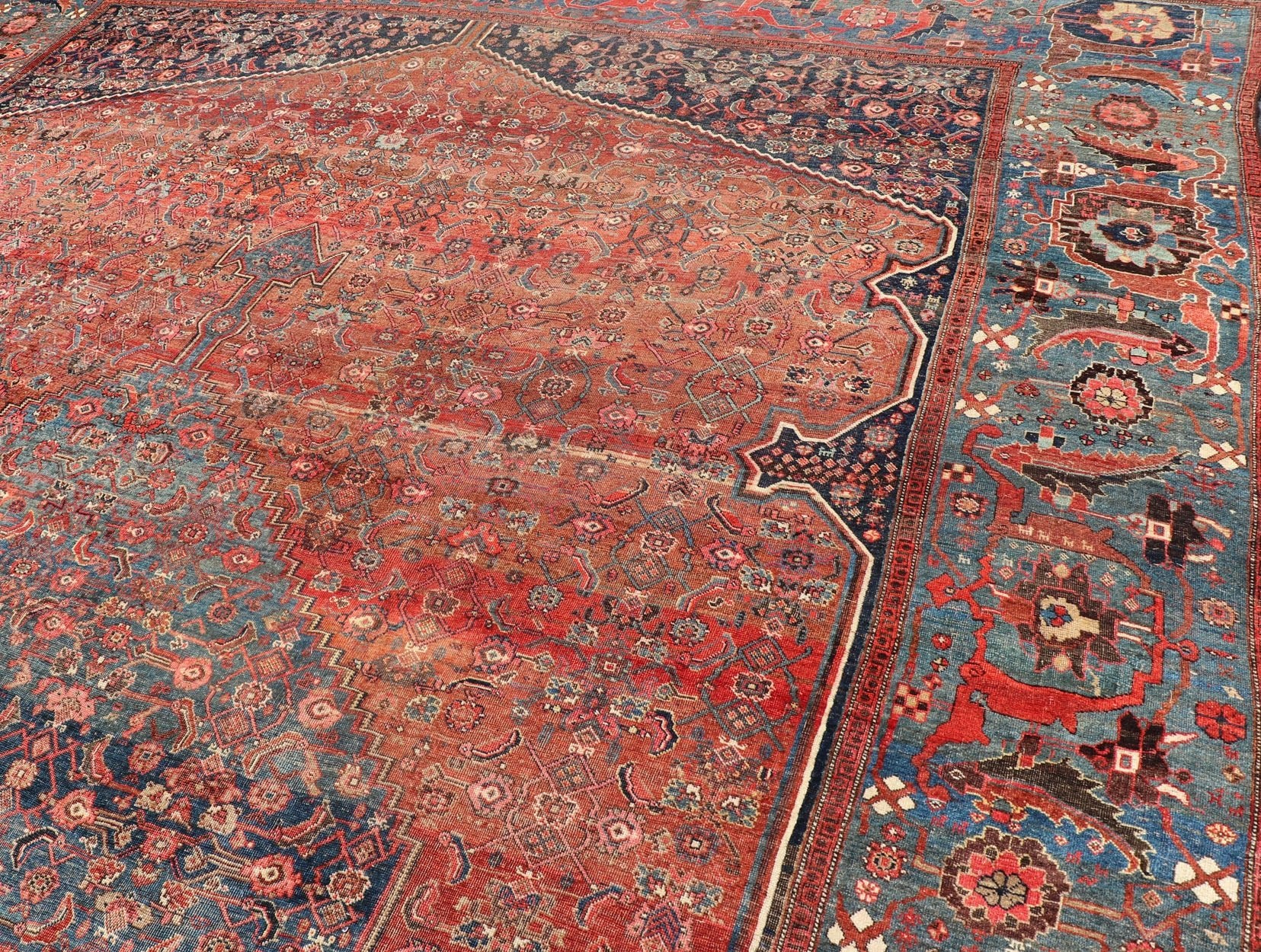 Very Large Antique Persian Bidjar Rug in Multi Shades of Blue, Tera - cotta & Red. Classic Bidjar in Tera - cotta and variety of beautiful red tones, framed by variegated shades of blue colors in the border with large Scale Geometrics. Bidjar antique r... - Keivan Woven ArtsV21 - 0106 - 14536