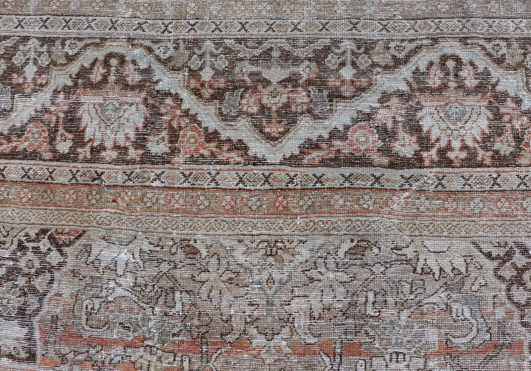 Distressed Antique Hand - Knotted Sultanabad Rug in Wool with Floral Design This antique Persian Sultanabad rug an all - over sub - geometric floral design rendered in orange and earthy tones, set upon an orange background. A complementary, multi - tie... - Keivan Woven ArtsV21 - 0501 - 15719
