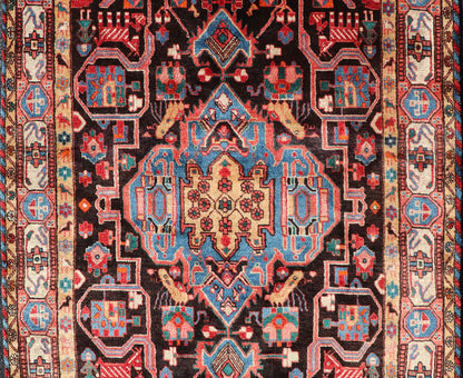Antique Persian Nahavand Rug with All - Over Sub - Geometric Tribal Design Measures: 4'3 x 9'4. This absolutely stunning Antique Nahavand (circa 1920s) features a symmetrical sub - geometric design rendered in shades of reds, blues, greens, cre... - Keivan Woven ArtsV21 - 1103 - 18341Rug
