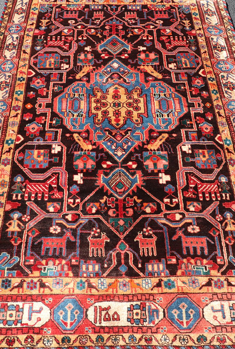 Antique Persian Nahavand Rug with All - Over Sub - Geometric Tribal Design Measures: 4'3 x 9'4. This absolutely stunning Antique Nahavand (circa 1920s) features a symmetrical sub - geometric design rendered in shades of reds, blues, greens, cre... - Keivan Woven ArtsV21 - 1103 - 18341Rug